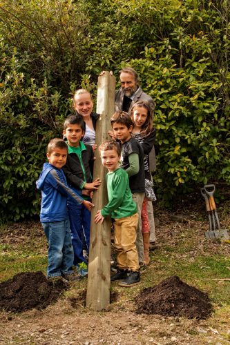 BWST Chair, Dave Butler, Works with the next generation to install the first post in the pest-proof fence.