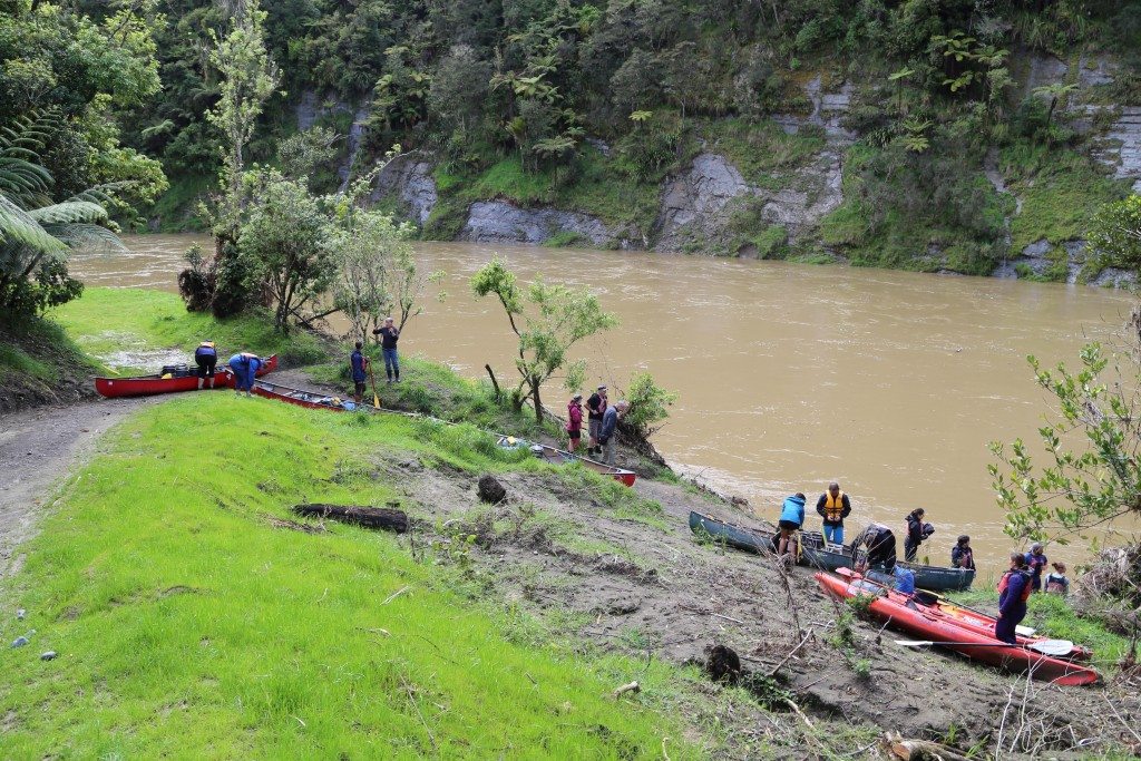 Kayakers prepare for take-off into a high river from John Coull Hut .Photo: Matthew Pike 